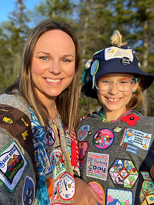 girl and Guider with badges