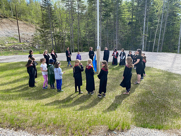 girls around the flag pole